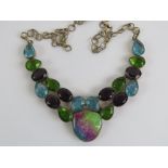 A handmade necklace having crescent shaped articulated panel to centre set with faceted oval and