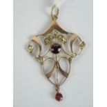 A delightful 9ct gold Edwardian garnet and seed pearl pendant of floral form, stamped 9ct, 4.