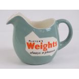A vintage T G Green & Co water jug 'Players Weights Always a Pleasure'.