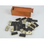 A vintage set of bone and ebonised wooden dominoes, in box.