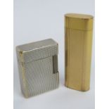 Two vintage lighters being a gold plater Cartier and a silver plated Dupont. Two items.