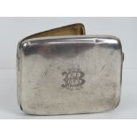 An HM silver cigarette case having gilded interior and 'A B' monogrammed to front,