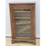 A c1930s leaded and glazed 'Old Charm' style single door cabinet, 72cm wide,