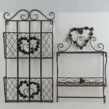 A black painted metal wall hanging shelf together with a similar newspaper rack. Two items.