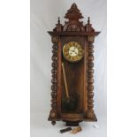 A late 19th century Vienna wall clock having clockwork movement,