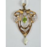 A delightful 9ct gold art nouveau pendant having large central oval cut peridot,