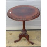 A single walnut topped circular side table raised over shaped base, 58cm dia, a/f.