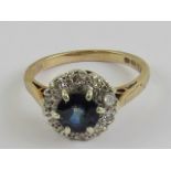 A 9ct gold sapphire and diamond ring, central round cut sapphire of royal blue hue approx 0.