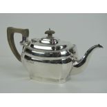 A HM silver teapot having wooden handle and finial, hallmarked London 1932 measuring 29.