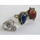 Three silver rings; orange goldstone size O, lapis lazuli size O,