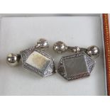 A pair of Sterling silver cuff links having unengraved square shaped cartouche with engraved border,