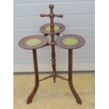 An unusual triform 'guinea' tray Lazy Susan type table having spindle turned and gadrooned