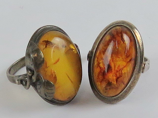 Two silver and Baltic amber rings; one with oval cabachon measuring approx 22 x 12mm hallmarked 925,