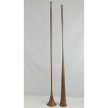 Two 20th century coaching or post horns, measuring 122cm and 124cm respectively.