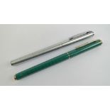 Two Sheaffer fountain pens; one stainless steel and one in green lacquer with yellow metal nib,