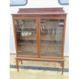 An astral glazed twin door mahogany bookcase,