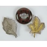 Two silver filigree brooches in the form of leaves, one gilded and marked sterling,