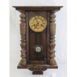 An eight day striking Vienna wall clock, the dial with paper chapter ring having Roman numerals,