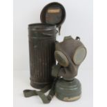 A German Industrial Workers Gas Mask dated 1933-34 with carry tin.