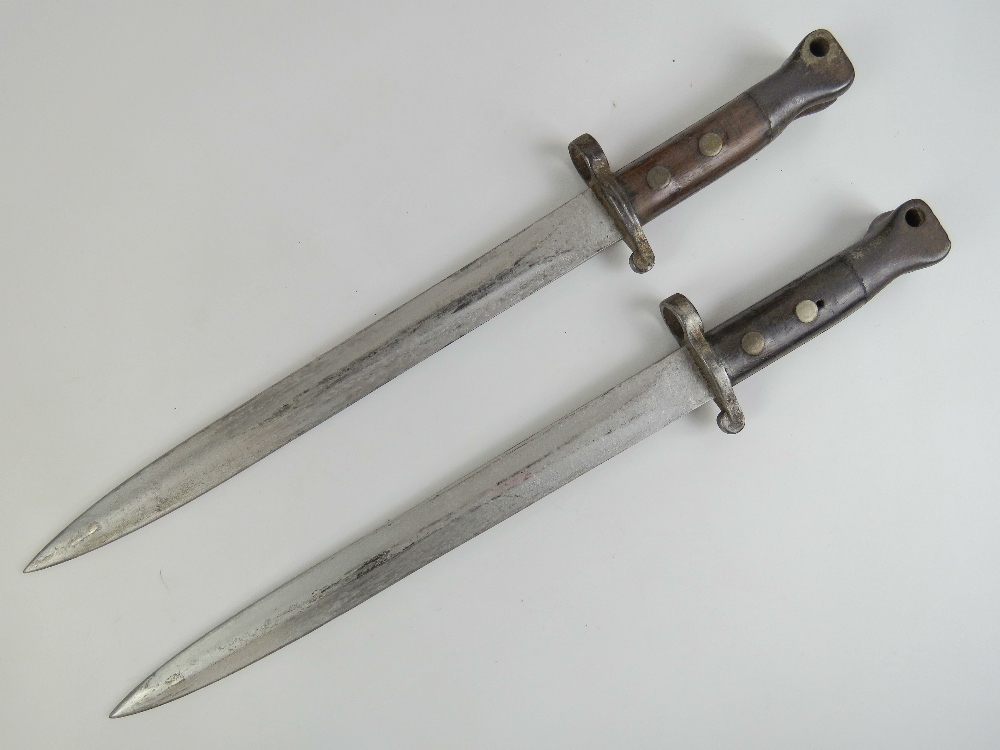 A pair of late Victorian British Metford bayonets each having 30cm blade and mounted upon a copper - Image 2 of 3