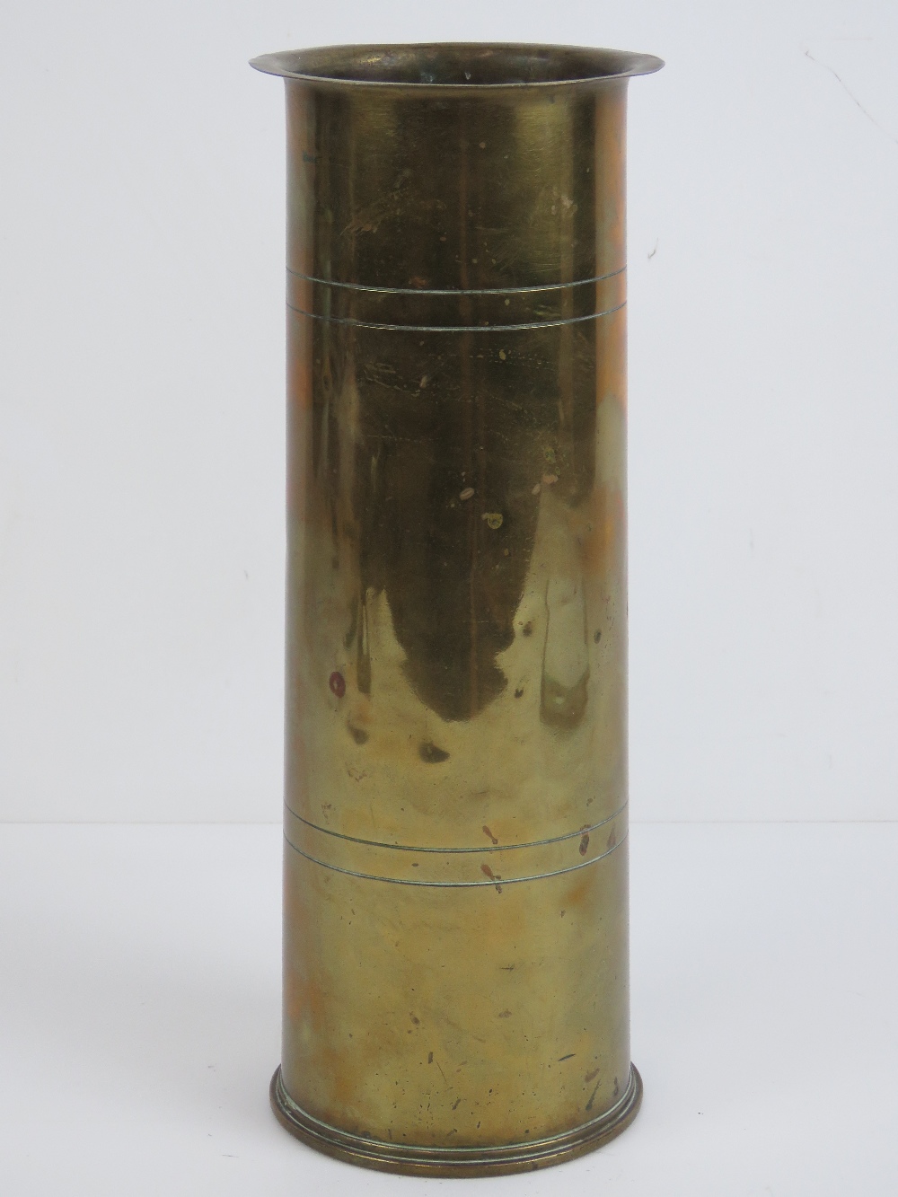 A WWI brass shell case dated 1916 having 'trench art' hammered over lip,