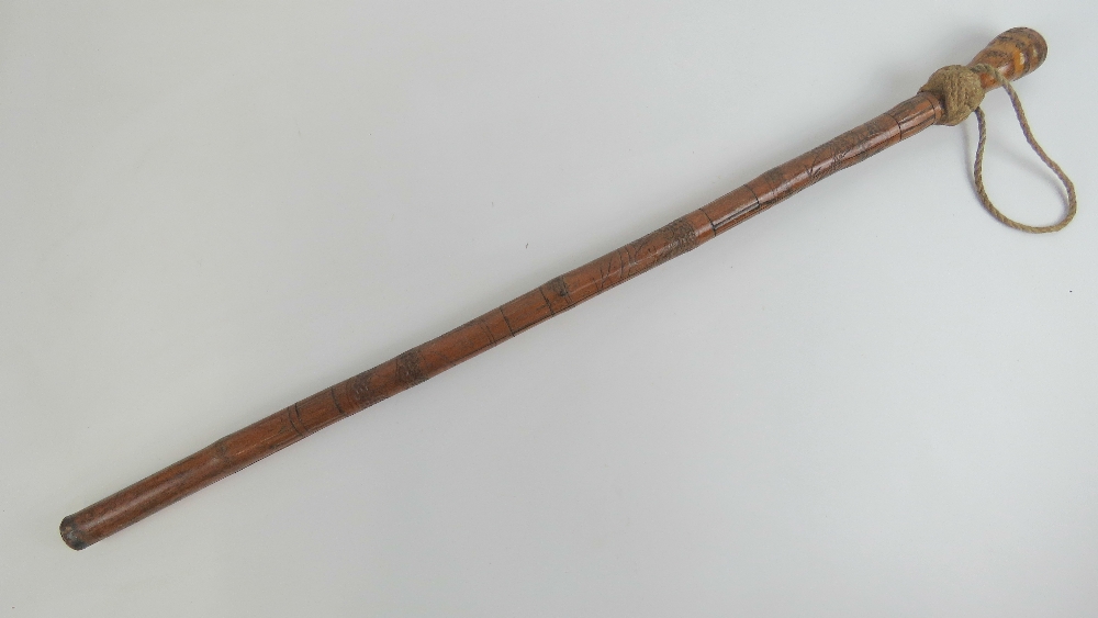 A WWII Japanese Swagger stick, made from Bamboo ad having Japanese carvings upon.