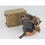 A WWII British civilian gas mask in tin. Mask a/f.