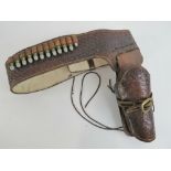 A Peacemaker cowboy holster with belt and inerts.