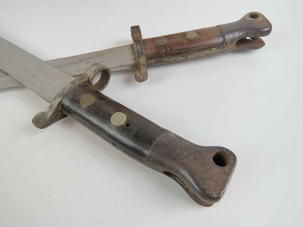 A pair of late Victorian British Metford bayonets each having 30cm blade and mounted upon a copper - Image 3 of 3