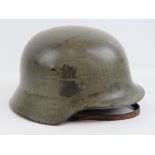 A WWII German Army M40 helmet with liner and chin strap,