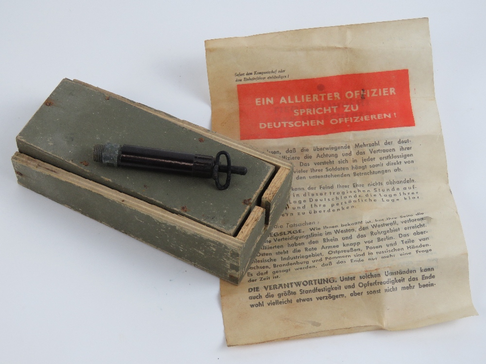 An early WWII Schutzenmine with fuse and instruction leaflet.