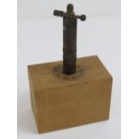 An inert German trip wire explosive marked Spreng-Korper upon and dated 1938, approx 12cm high.