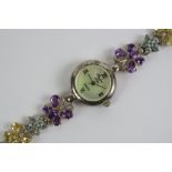 A silver and gemstone ladies wristwatch