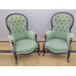 A pair of ebonised fireside chairs havin