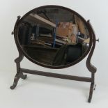 An Edwardian oval oak framed toilet mirr