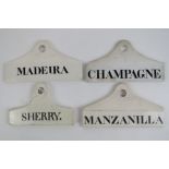Four ceramic liquer labels for sherry, champagne, manzanilla and Madeira, each measuring 14cm wide.