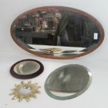 A quantity of mirrors including on oval oak framed bevelled edge mirror 63cm wide,
