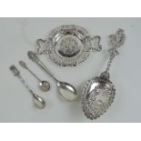 Three Continental white metal items being twin handled tray, and two decorative spoons.