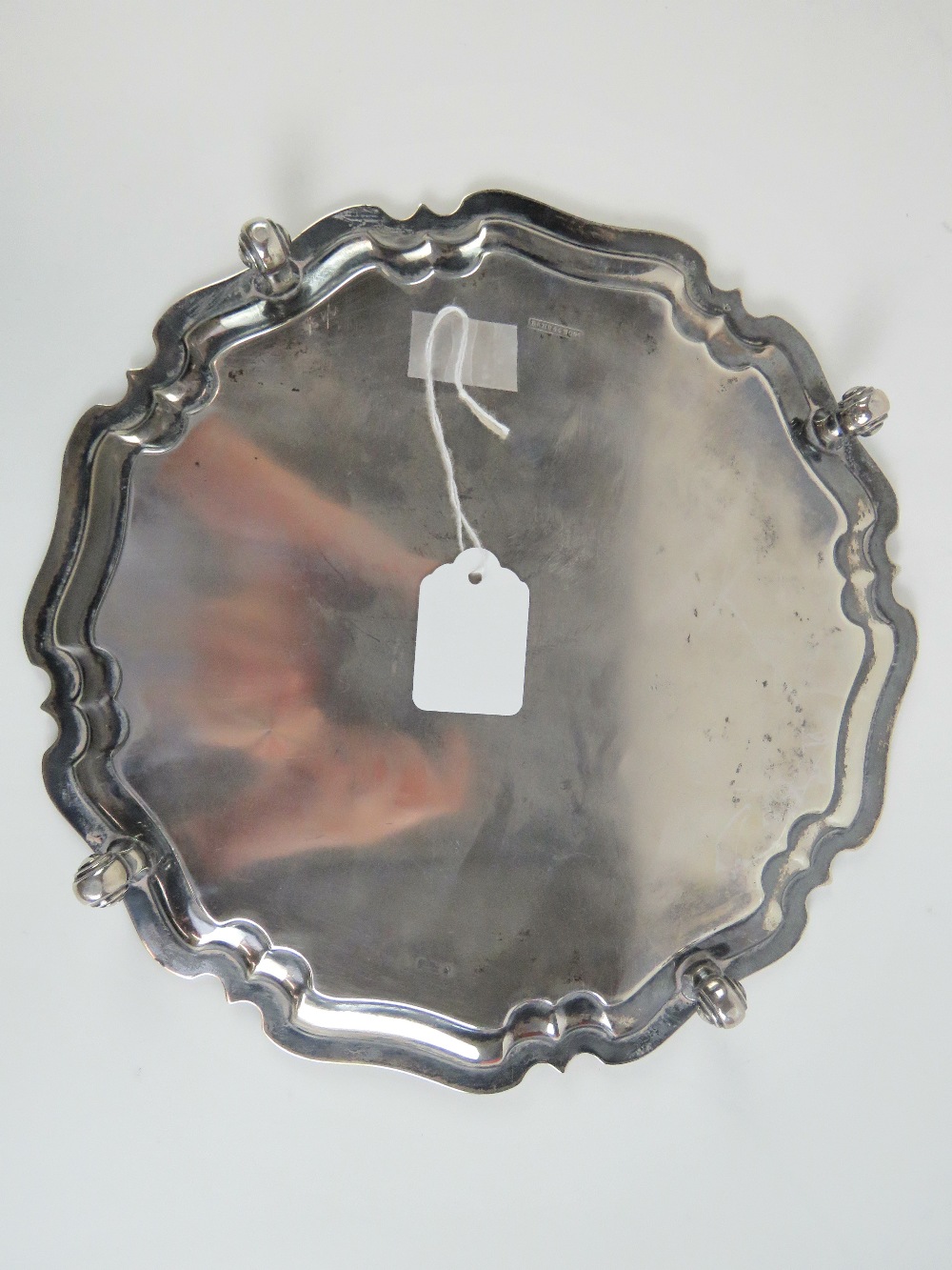 A HM silver salver having pie crust edge and raised over four scroll feet, - Image 3 of 3