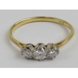 An 18ct gold and diamond three stone ring, with Michael Jones insurance valuation for £1,150.