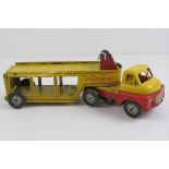 A c1960s clockwork toy car transporter articulated lorry, with hand cranked winch, 28cm in length.