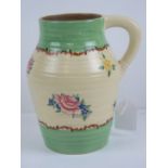 A Clarice Cliff Pompedour floral decorated handled jug,17.5cm high.