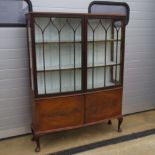 An Edwardian bow fronted two door glazed display case,