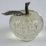 A small glass paperweight in the form of an apple having plated core and leaf, 8cm high.