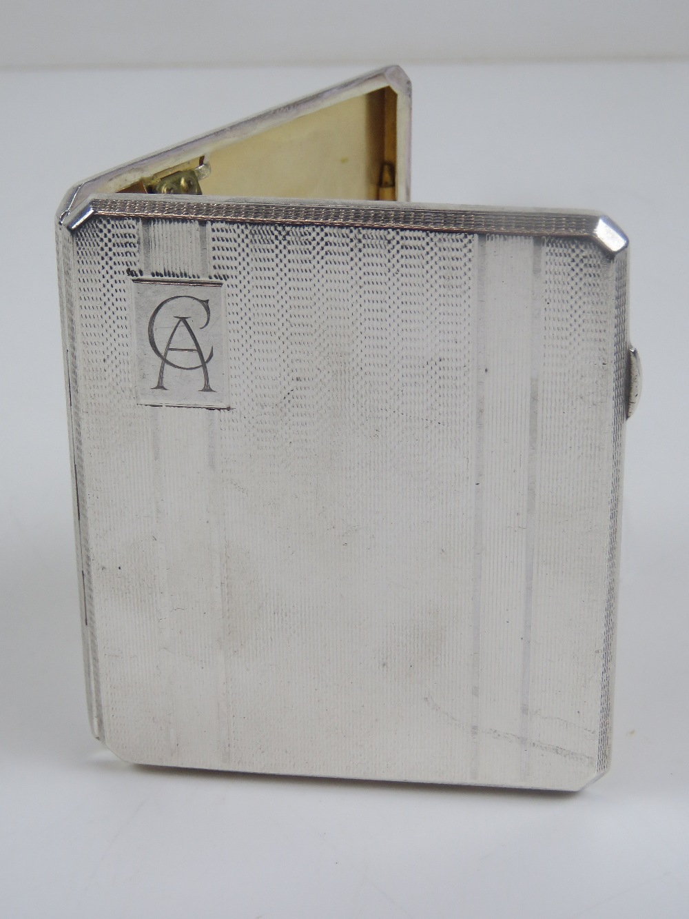 A HM silver octagonal cigarette case having engine turned engraved pattern throughout,