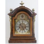 A walnut cased eight day striking twin fusee table or bracket clock having arched top dial with