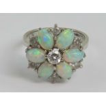 An 18ct white gold opal and diamond floral cluster ring,