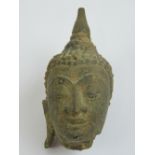 A 16th / 17th century Thai stone Buddha head, 7cm high.