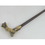 A walking stick having brass handle in the form of a female figure.