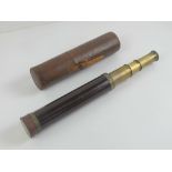A three drawer brass telescope marked Doland London upon, with leather case, extending to 63cm.
